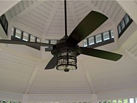 <b>The inside to a gazebo with a pagoda and ceiling fan</b>